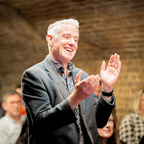 Guest applauding at the rebrand event